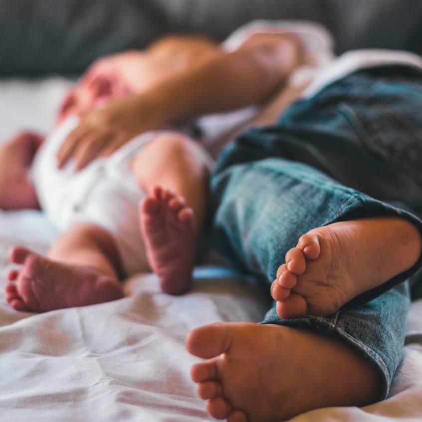 Hermana mayor ayudando a su hermano pequeño a prepararse para la escuela