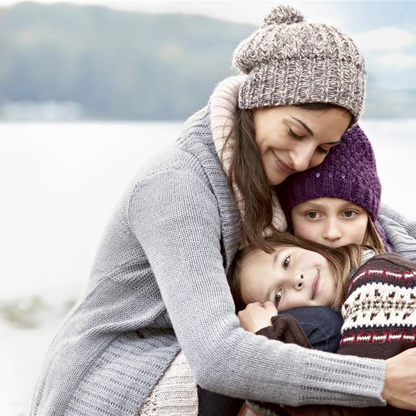 Mamá abrazando a sus dos hijas