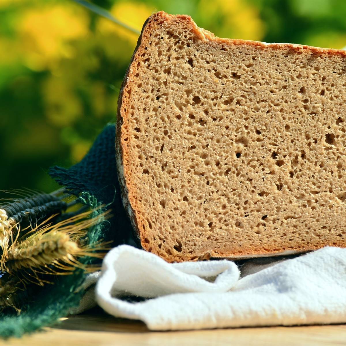 Pan de centeno sobre un paño con una espiga al lado